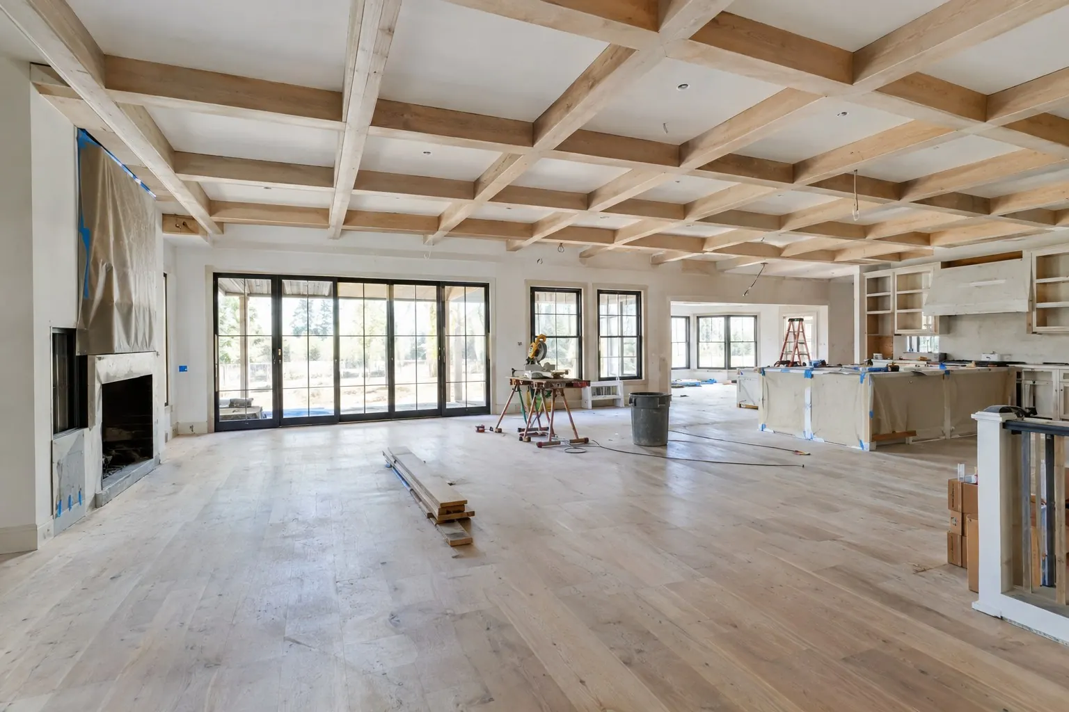 Large open living space during reconstruction with coffered ceiling